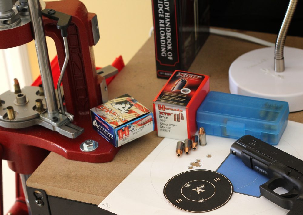 Metallic cartridge handloading tools arranged on a workbench